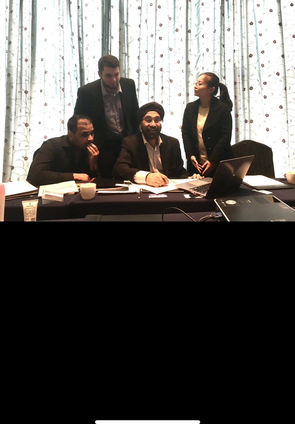 Koorosh at a trade show reviewing product